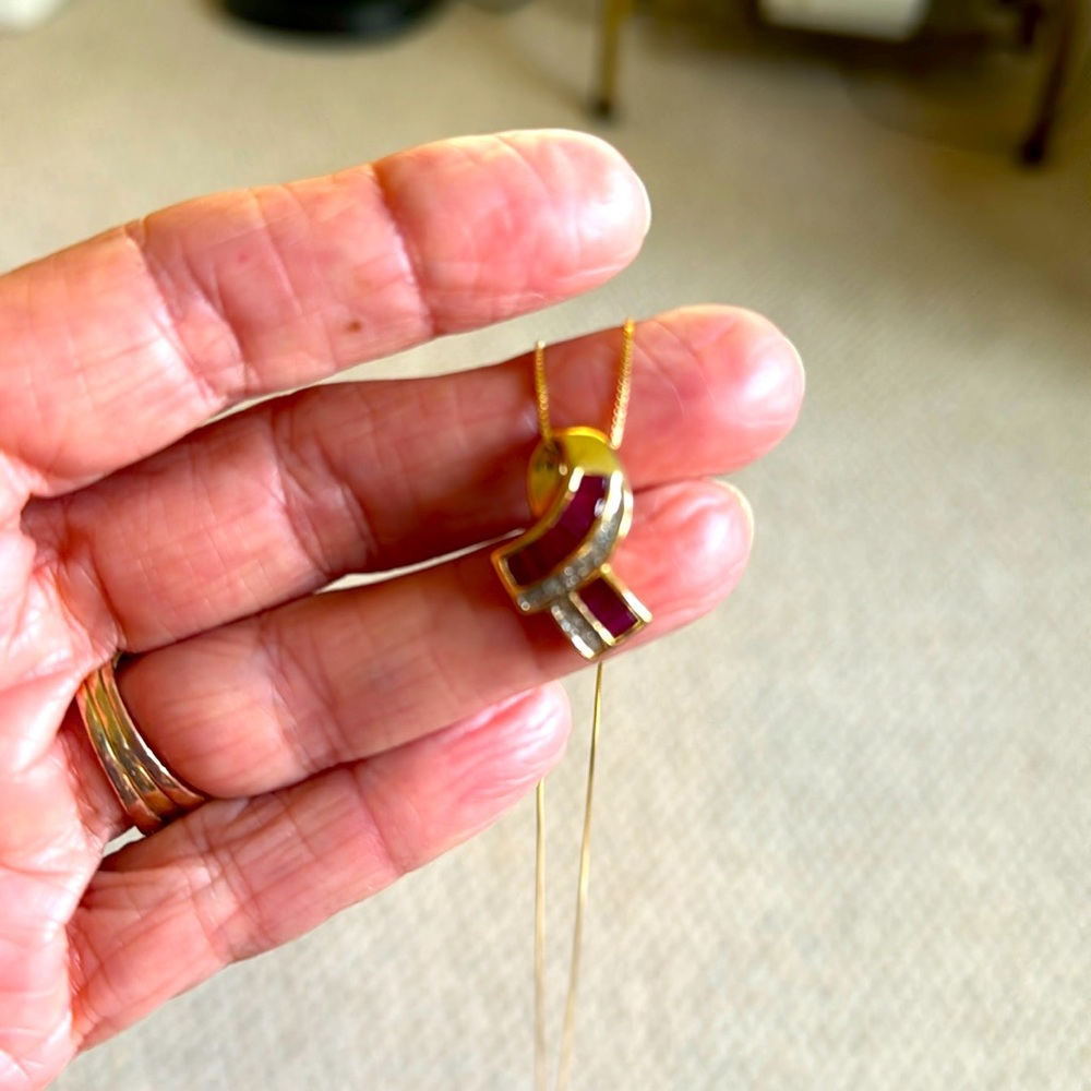 10 carat gold ruby and diamond pendant with 18 inch chain.